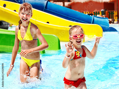 Photo: Children on water slide at aquapark. Children on water slide at aquapark.