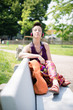 beautiful hipster short hair woman listening music in the park