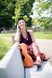 beautiful hipster short hair woman listening music in the park
