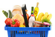 Plastic shopping basket with variety of grocery products