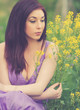 girl sitting in a summer field with flowers