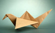 Origami crane on grey background