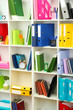 White office shelves with different stationery, close up