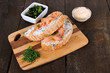 Photo: Fish sandwiches on cutting board on wooden table Fish sandwiches on cutting board on wooden table