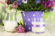Beautiful bouquet in pail on wooden table on natural background