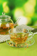 Kettle and cup of tea with linden