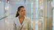 young, pretty business woman chooses clothes in shop