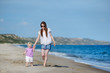 Mother and daughter walking along a beach