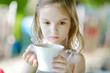 Adorable little girl drinking hot chocolate