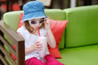 Adorable little girl drinking milkshake