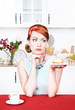 Photo: Sad beautiful woman looking on cake Sad beautiful woman looking on cake
