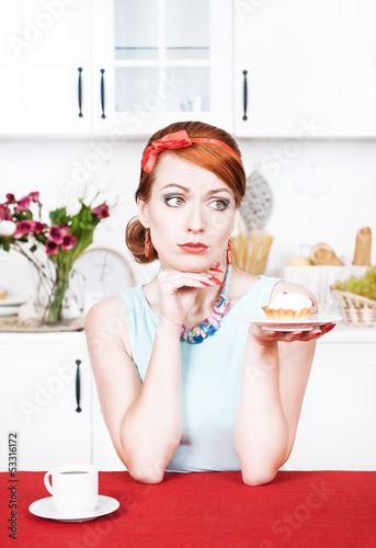 Photo: Sad beautiful woman looking on cake Sad beautiful woman looking on cake
