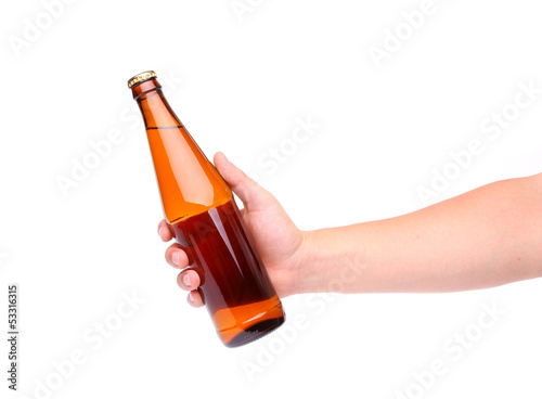 Photo: A hand holding up a yellow beer bottle A hand holding up a yellow beer bottle