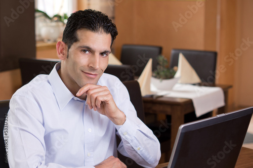 Photo: Friendly Businessman working in Restaurant Friendly Businessman working in Restaurant