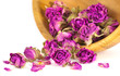 Wooden bowl filled with dried rose buds prepared for Spa