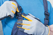 Repairman adjusting his working overalls