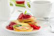 Pancakes with strawberries, strawberry sorbet and vanilla sauce.