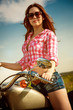 Biker girl sitting on motorcycle