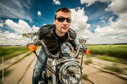 Photo: Biker racing on the road Biker racing on the road