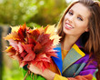 Photo: Portrait of beautiful young woman in autumn park. Portrait of beautiful young woman in autumn park.