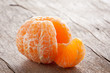 Raw skinned mandarin on wooden table