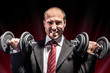 Businessman lifting weights