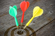 Darts hitting  target on a wooden planks