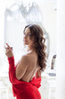 Photo: Image of smiling slim brunette posing in red dress Image of smiling slim brunette posing in red dress
