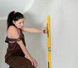 Woman finding a straight line spirit level