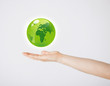 Foto: mans hand holding green globe mans hand holding green globe