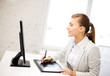 businesswoman with drawing tablet in office