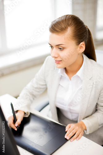 Photo: businesswoman with drawing tablet in office businesswoman with drawing tablet in office