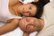 Vertical image of a couple lying head to head