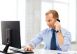 smiling businessman with smartphone in office