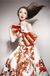 young beautiful asian brunette in gorgeous dress, motion shot