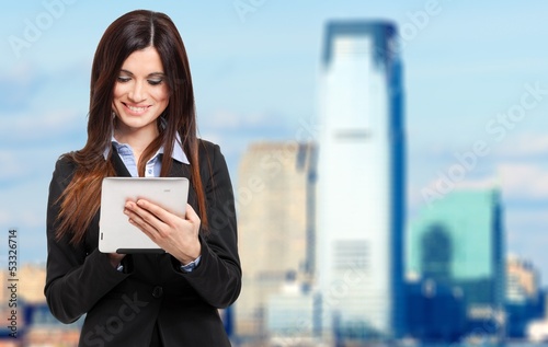 Photo: Beautiful businesswoman using a digital tablet Beautiful businesswoman using a digital tablet