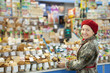 Mature woman chooses sweets