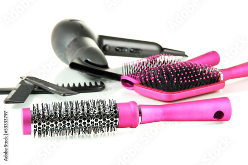Photo: Color comb brushes, hairdryer isolated on white Color comb brushes, hairdryer isolated on white
