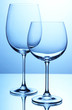 Empty wine glasses arranged on blue background