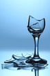 Broken wineglass on blue background