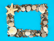 Frame of sea stones on color background