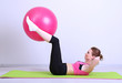 Photo: Portrait of beautiful young woman exercises with gym ball Portrait of beautiful young woman exercises with gym ball