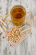 Beer in glass and nuts on napkin on wooden table