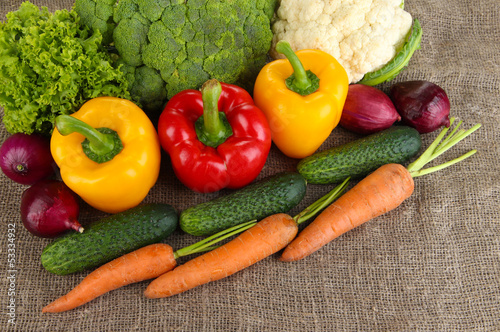 Photo: Fresh vegetables on burlap background Fresh vegetables on burlap background