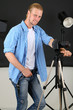 Handsome photographer with camera at working,