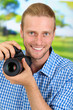 Handsome photographer with camera,on bright background