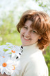 Woman with a bouquet of daisies