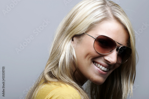 Photo: Attractive and cheerful female model in sunglasses Attractive and cheerful female model in sunglasses