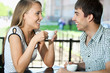 Beautiful young couple at cafe