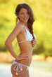 Happy young woman posing while on the beach